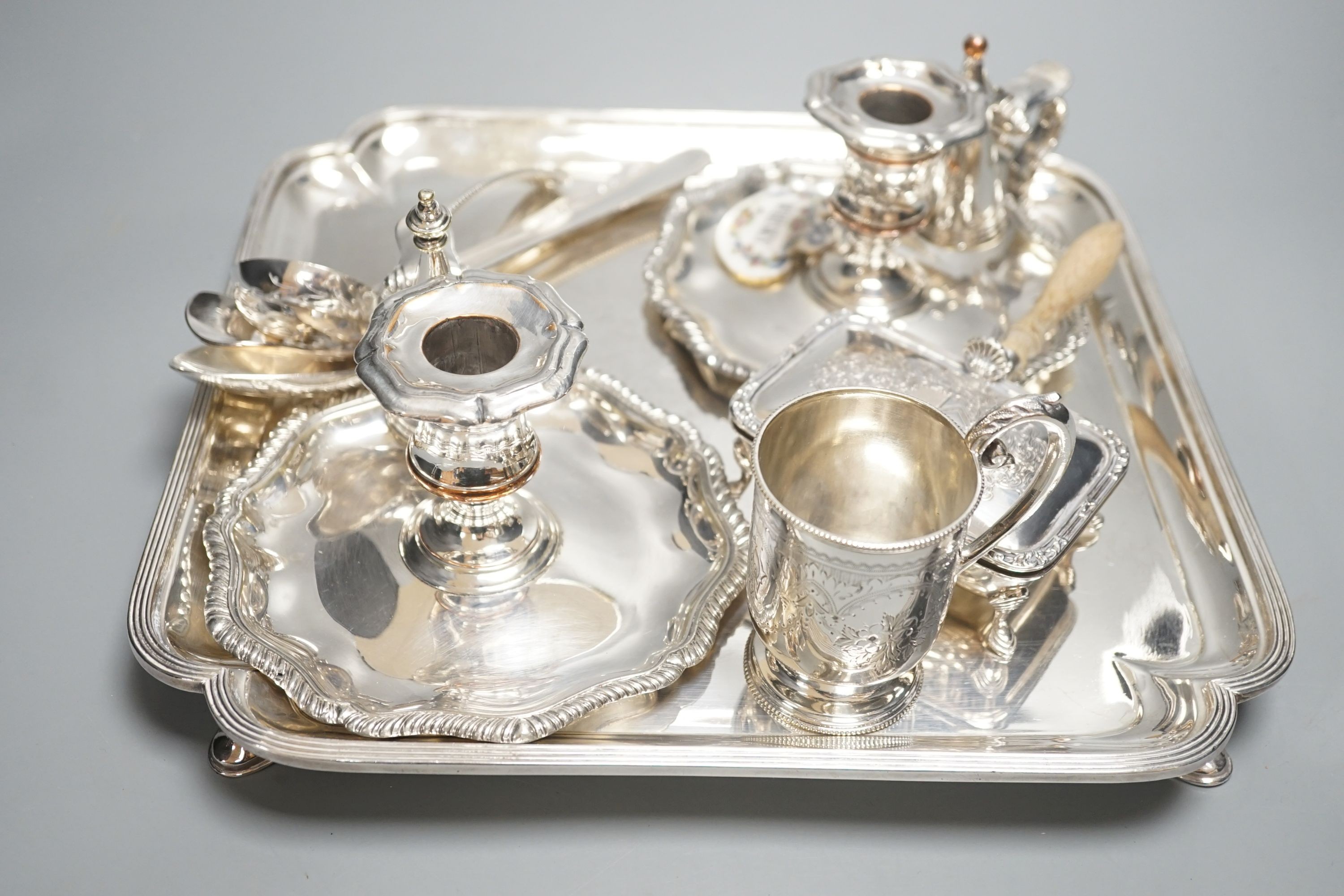 A plated salver, a pair of chambersticks and other plated flatwares